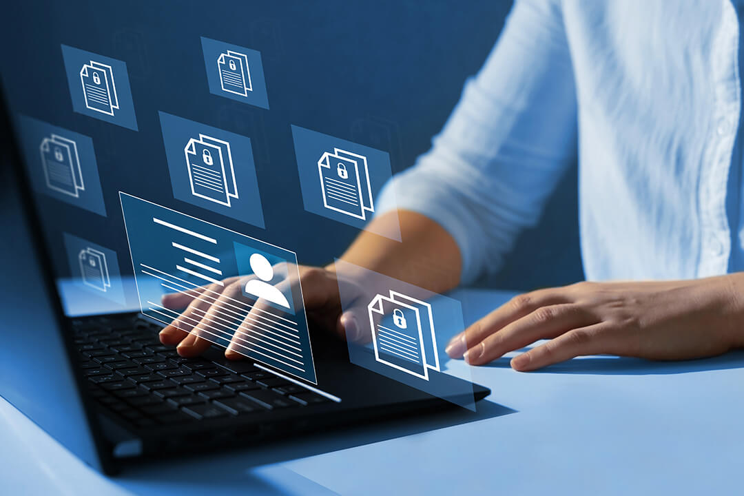 Person tippt am Laptop, darüber schweben digitale Dokumente mit Schloss-Symbol